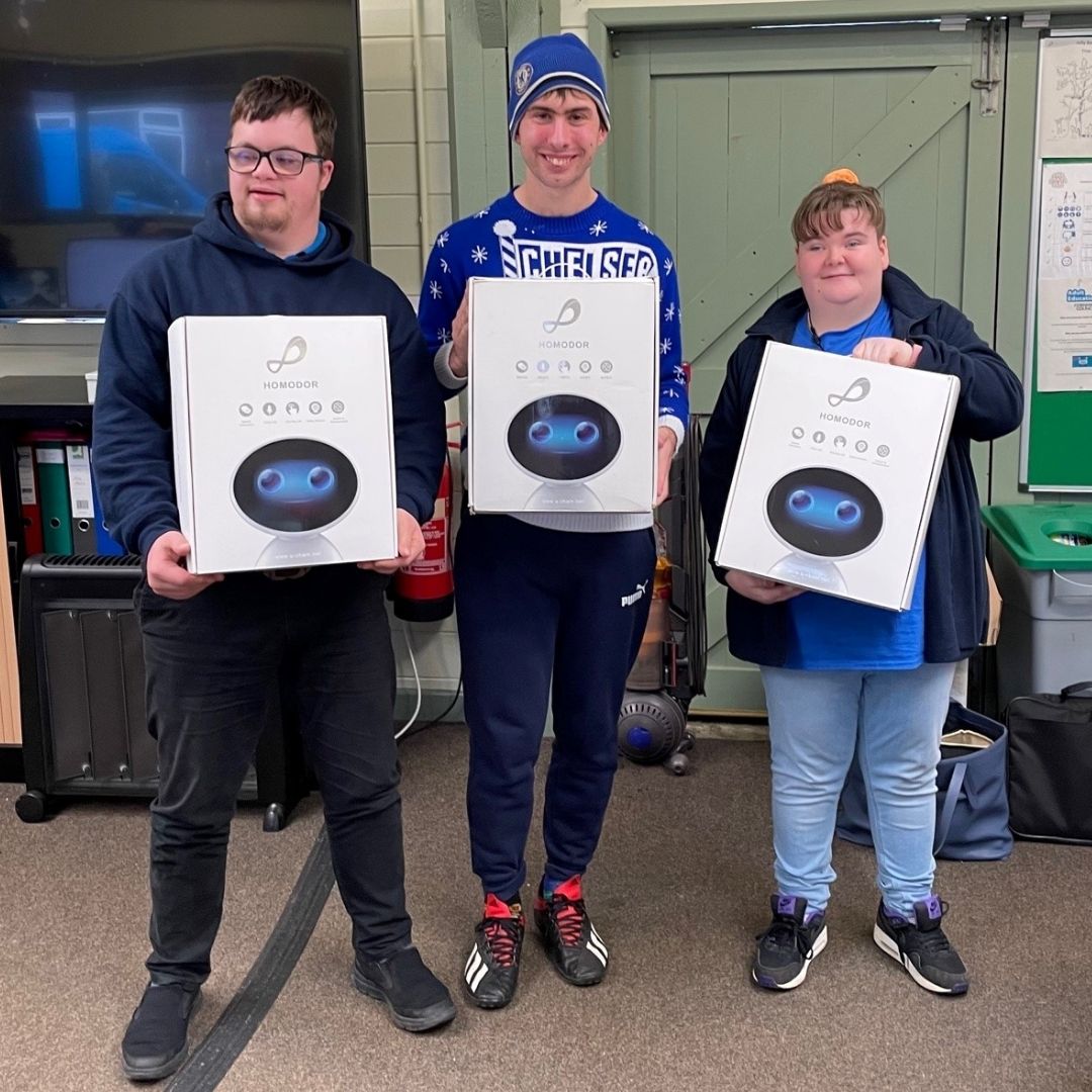 Three people with learning disabilities Kehelland Trust with robotics Three people with learning disabilities Kehelland Trust with robotics